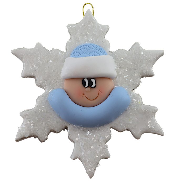 Baby ornament with infant face and blue hat on glittery white snowflake base.