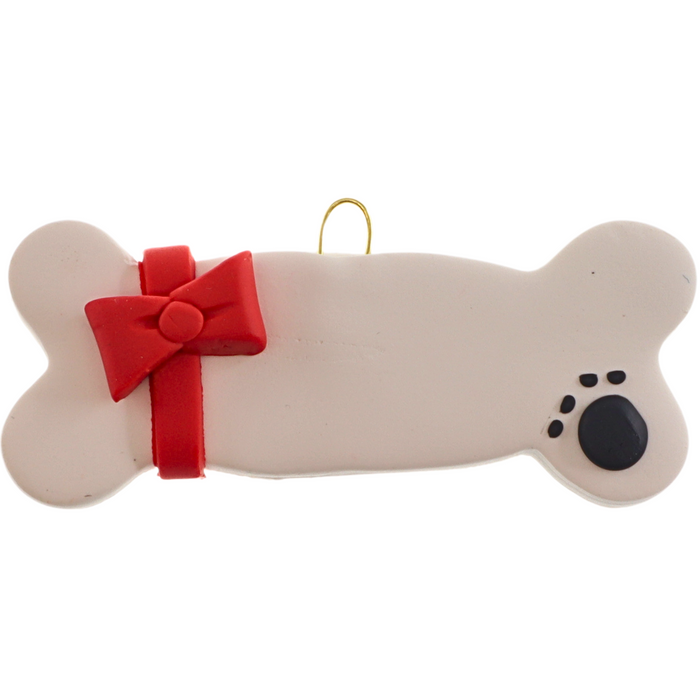 Ornament of dog bone with ribbon and paw print.