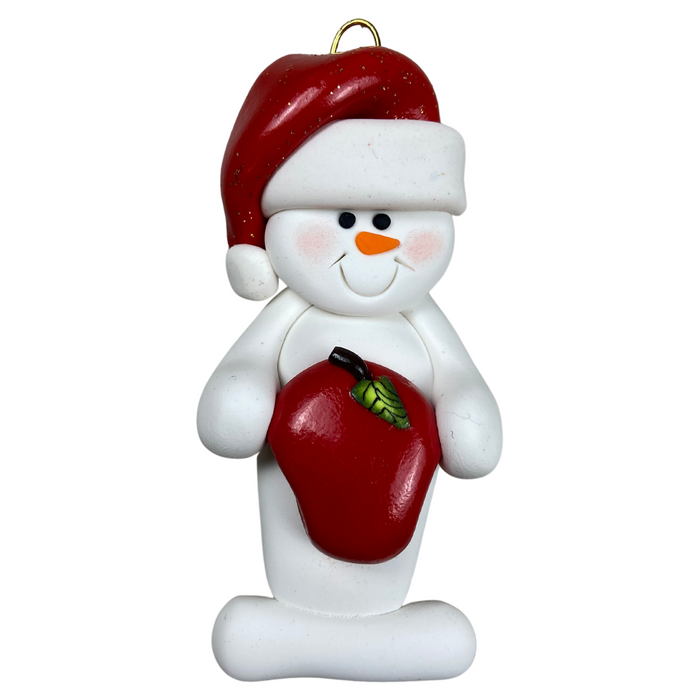 Ornament of white snowman in red hat holding a shiny red apple.