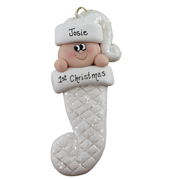 Ornament with infant head in a white glitter hat poking out of a white glitter stocking, personalized with name.