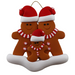 Family ornament with 3 brown gingerbread figures in red Christmas hats.