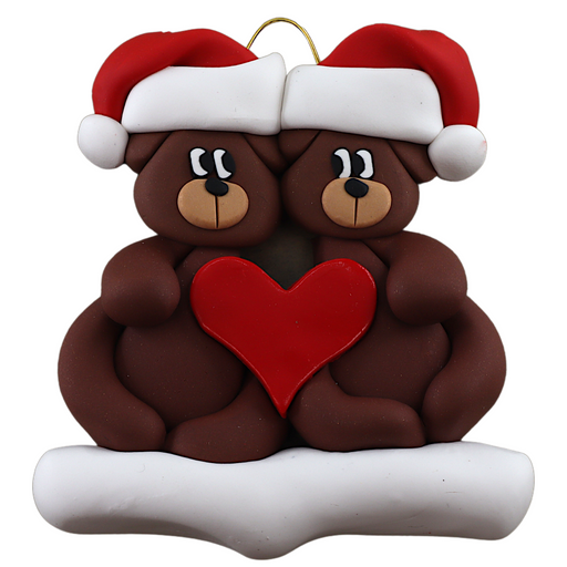 A couple’s ornament of two brown bears holding a red heart together.