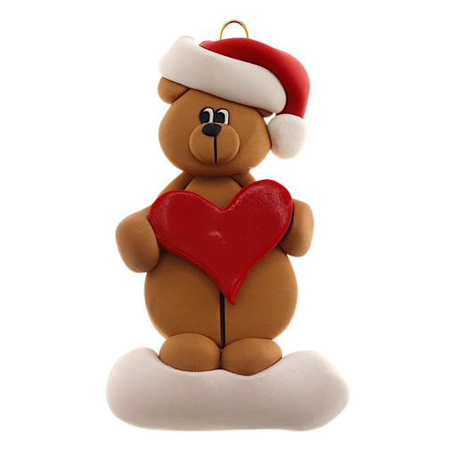 Tan bear in red festive hat holding red heart ornament.