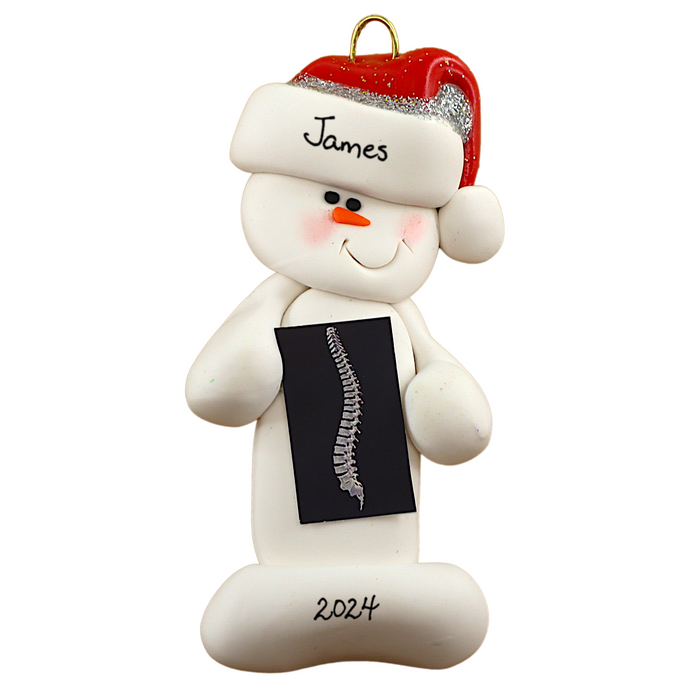 Ornament of white snowman in red hat holding black and white x-ray of a spine, personalized with name.