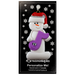 Ornament of white snowman in red hat holding a purple musical note, on display backing card.
