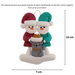 Ornament of snowman couple in red and green shirts and hats with grey cat in Christmas hat, graphed to show size (7x10cm).