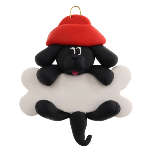 Ornament of black dog in red hat hanging on a white bone.