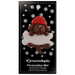 Ornament of brown dog in red hat hanging on a white bone, on display backing card.