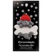 Ornament of grey dog in red hat hanging on a white bone, on display backing card.
