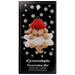 Ornament of tan dog in red hat hanging on a white bone, on display backing card.