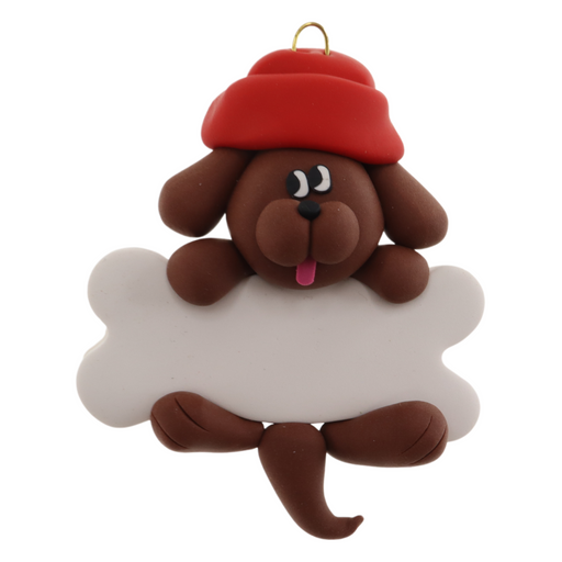 Ornament of brown dog in red hat hanging on a white bone.