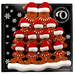 Family ornament with 13 brown gingerbread figures in red Christmas hats, on display backing card.