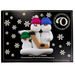 Family ornament with 3 white snowmen in bright hats, holding a hockey stick, on display backing card.