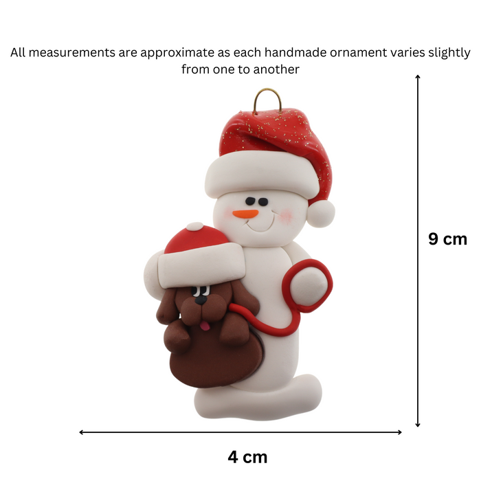 Ornament of white snowman in red hat holding a brown dog on a leash, graphed to show size (4x9cm).