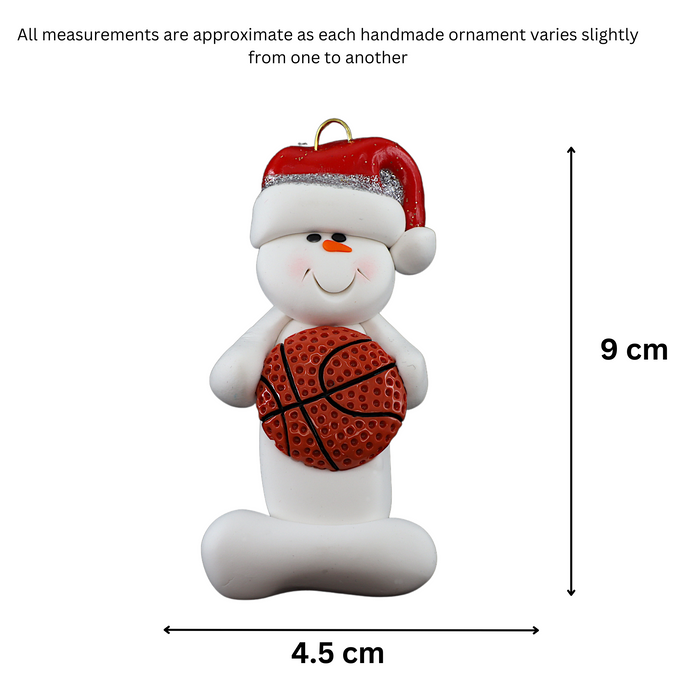 Ornament of white snowman in red hat holding a basketball, graphed to show size (4.5x9cm).