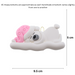 Ornament of white sleeping polar bear baby in a pink hat, graphed to show size (9.5x5cm)
