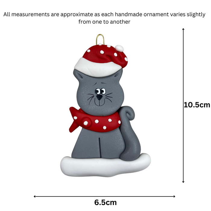 Ornament of grey cat in red and white polka dot Christmas hat and scarf, graphed to show size (6.5x10.5cm).