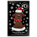 Ornament of brown dog in a red and white polka dot Christmas hat and scarf, on display backing card.