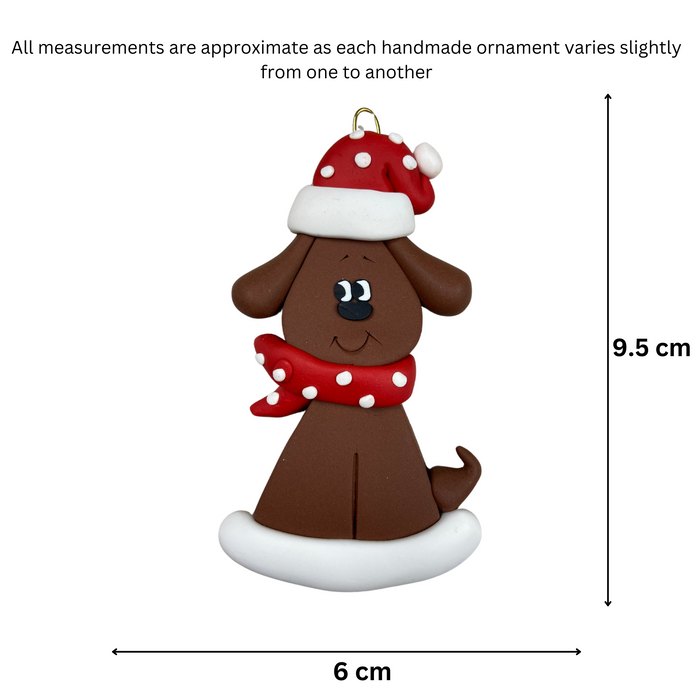 Ornament of brown dog in a red and white polka dot Christmas hat and scarf, graphed to show size (6x9.5cm).