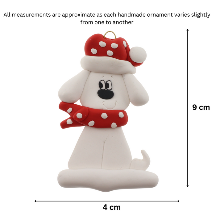 Ornament of white dog in a red and white polka dot Christmas hat and scarf, graphed to show size (4x9cm).