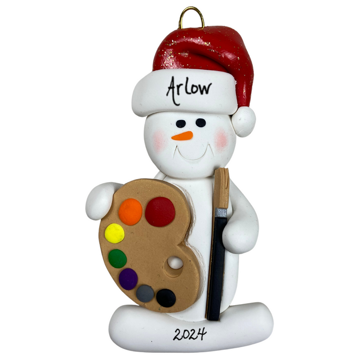 Ornament of white snowman in red hat holding a paint palette and paintbrush, personalized with name.