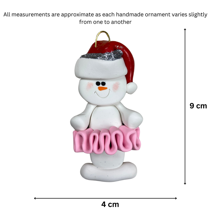 Ornament of white snowman in red hat wearing a pink tutu, graphed to show size (4x9cm).