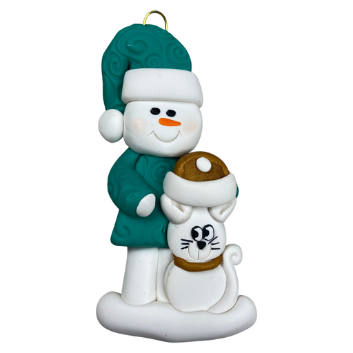 Ornament of snowman in a green shirt and hat with white cat in Christmas hat.