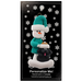 Ornament of snowman in green shirt and hat with black dog in Christmas hat, on display backing card.