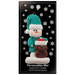 Ornament of snowman in green shirt and hat with brown dog in Christmas hat, on display backing card.