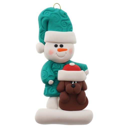 Ornament of snowman in green shirt and hat with brown dog in Christmas hat.